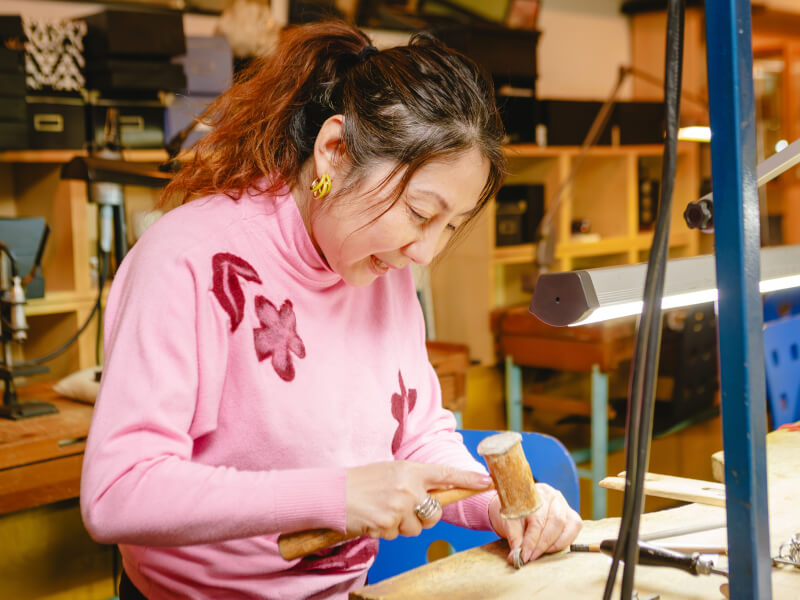 Woman hammering a ring in a jewellery making class
